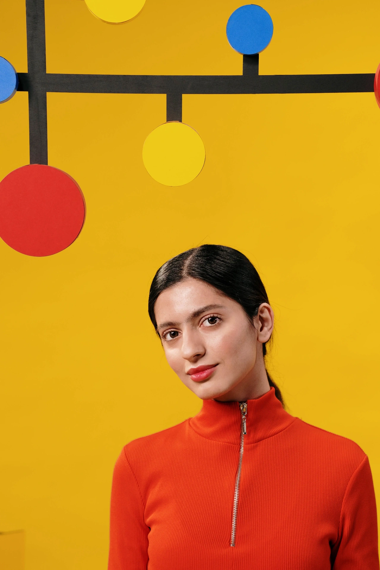 Two figures in bold colour blocks facing each other